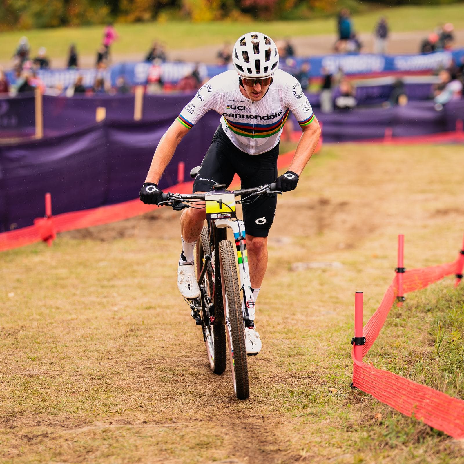 Cross-country World Cup racer in the rainbow-striped leader's kit