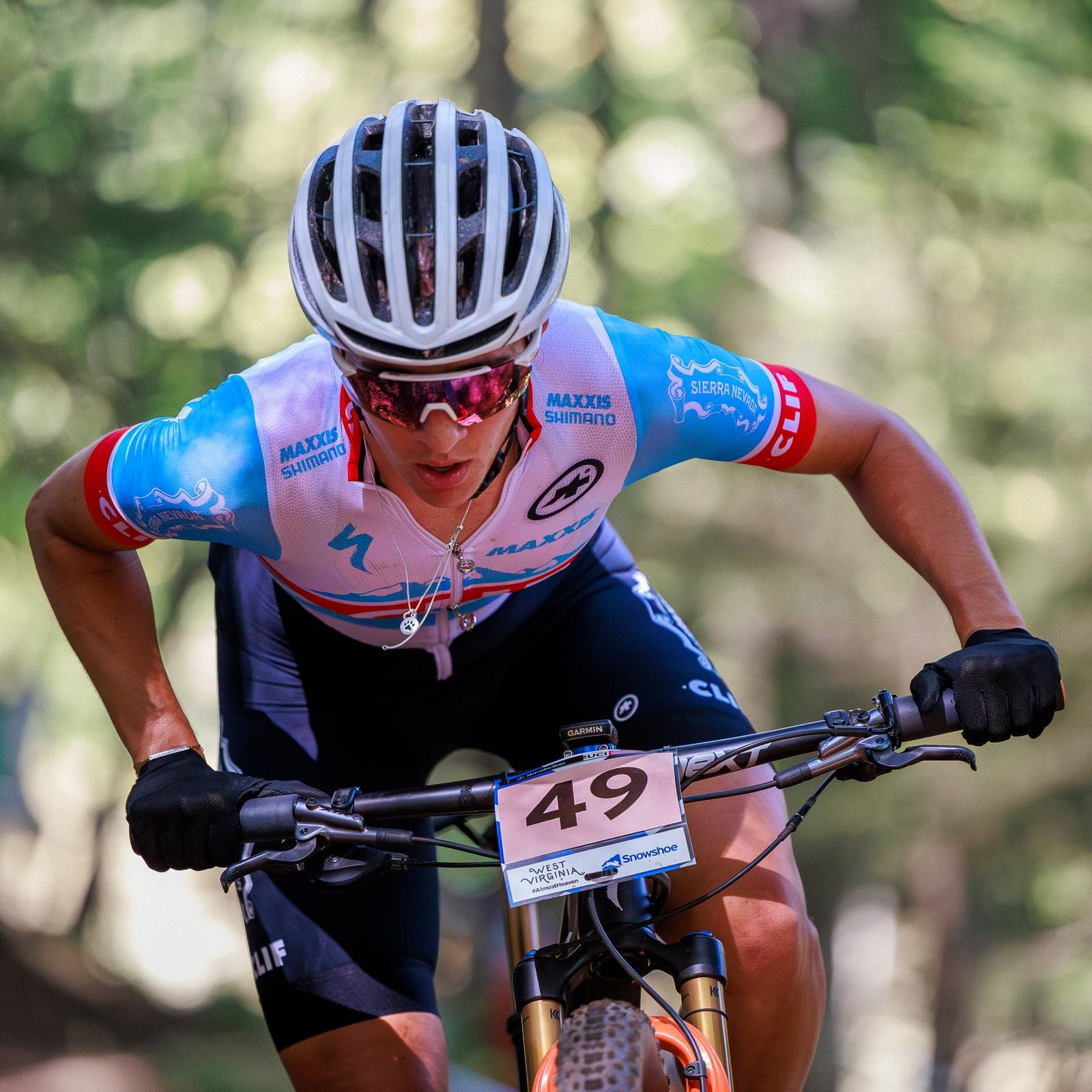 Women's cross-country World Cup racer climbing a rooted section